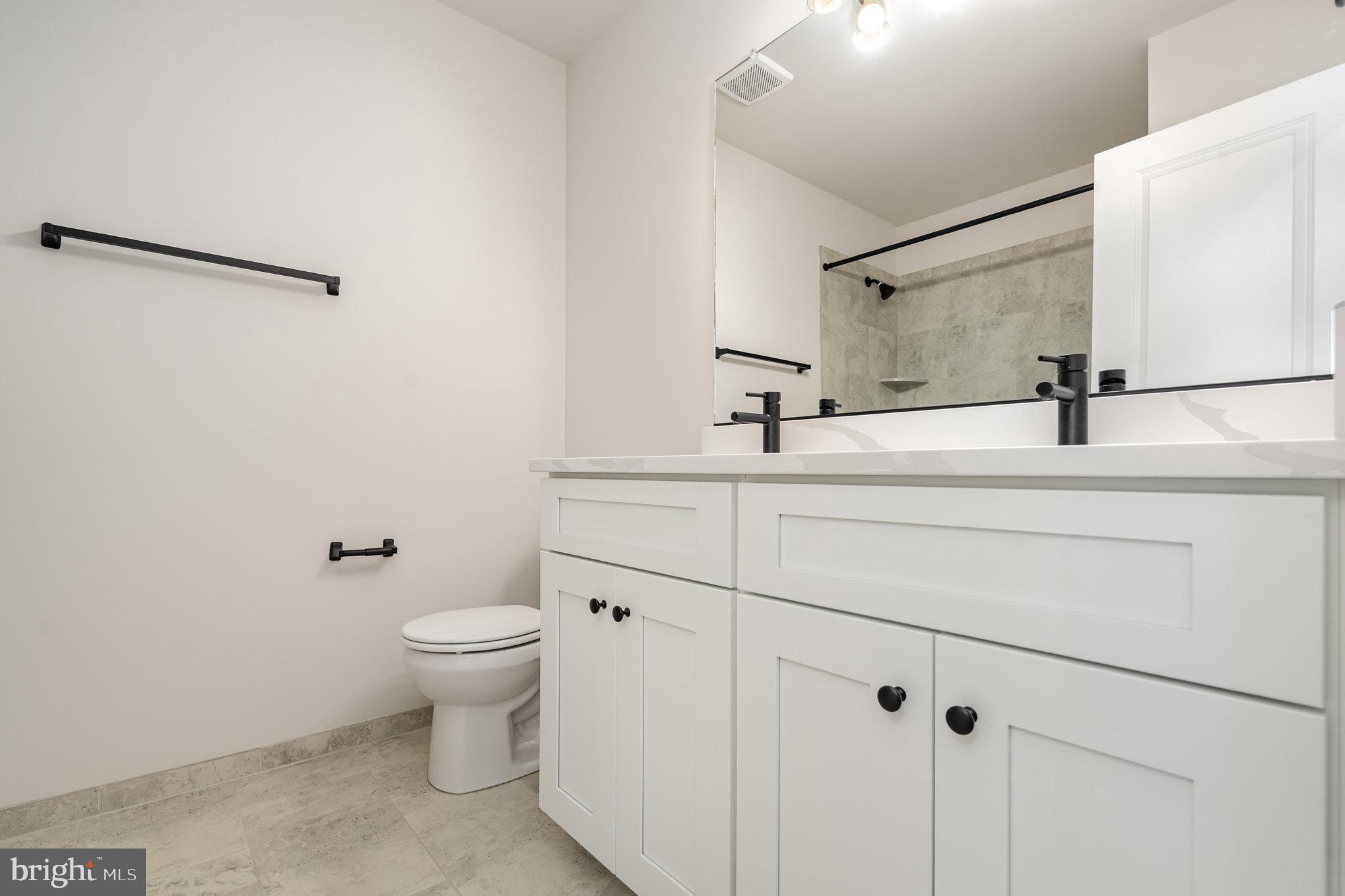 627 Rock Hill Church Road Stafford, VA 22556 - Photo 43 of 54 a bathroom with a sink toilet and mirror