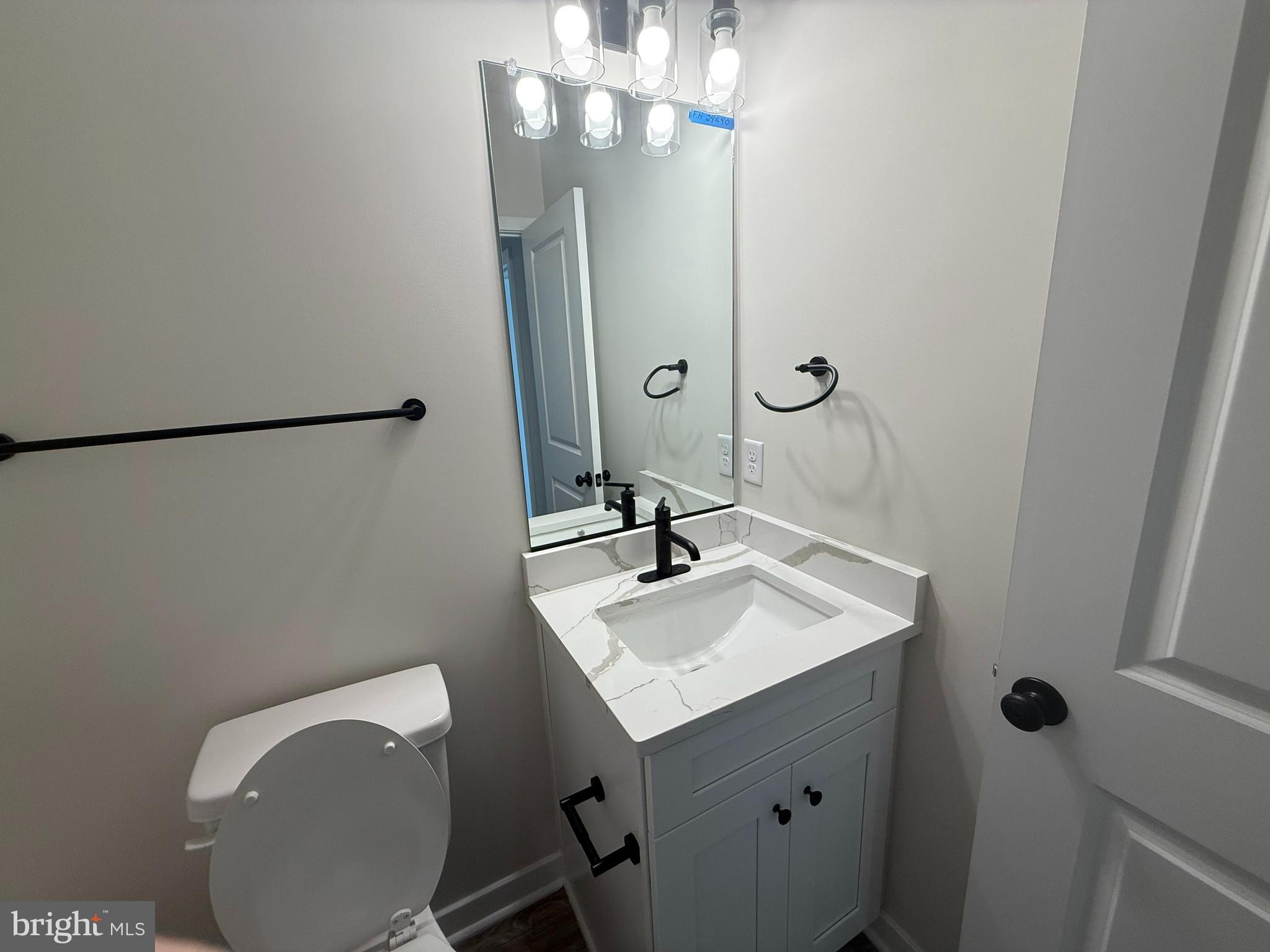 627 Rock Hill Church Road Stafford, VA 22556 - Photo 53 of 54 a bathroom with a sink vanity mirror and toilet