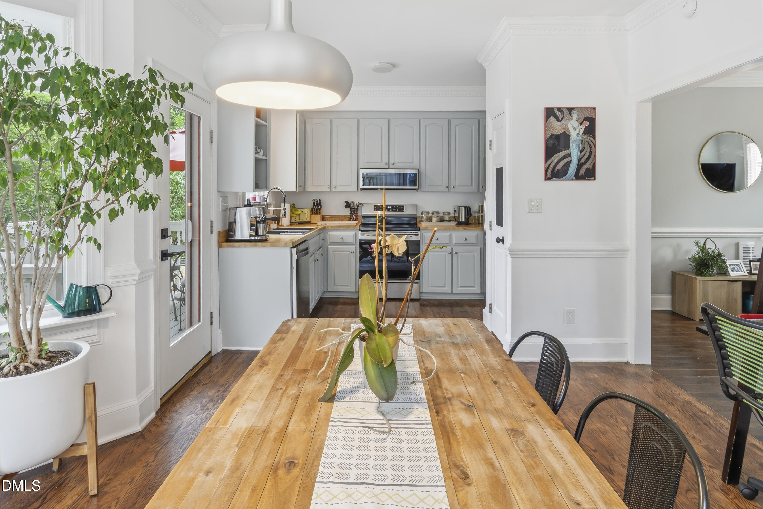 3004 West Annaley Drive Raleigh, NC 27604 - Photo 17 of 44 a dining room with stainless steel appliances a table and chairs