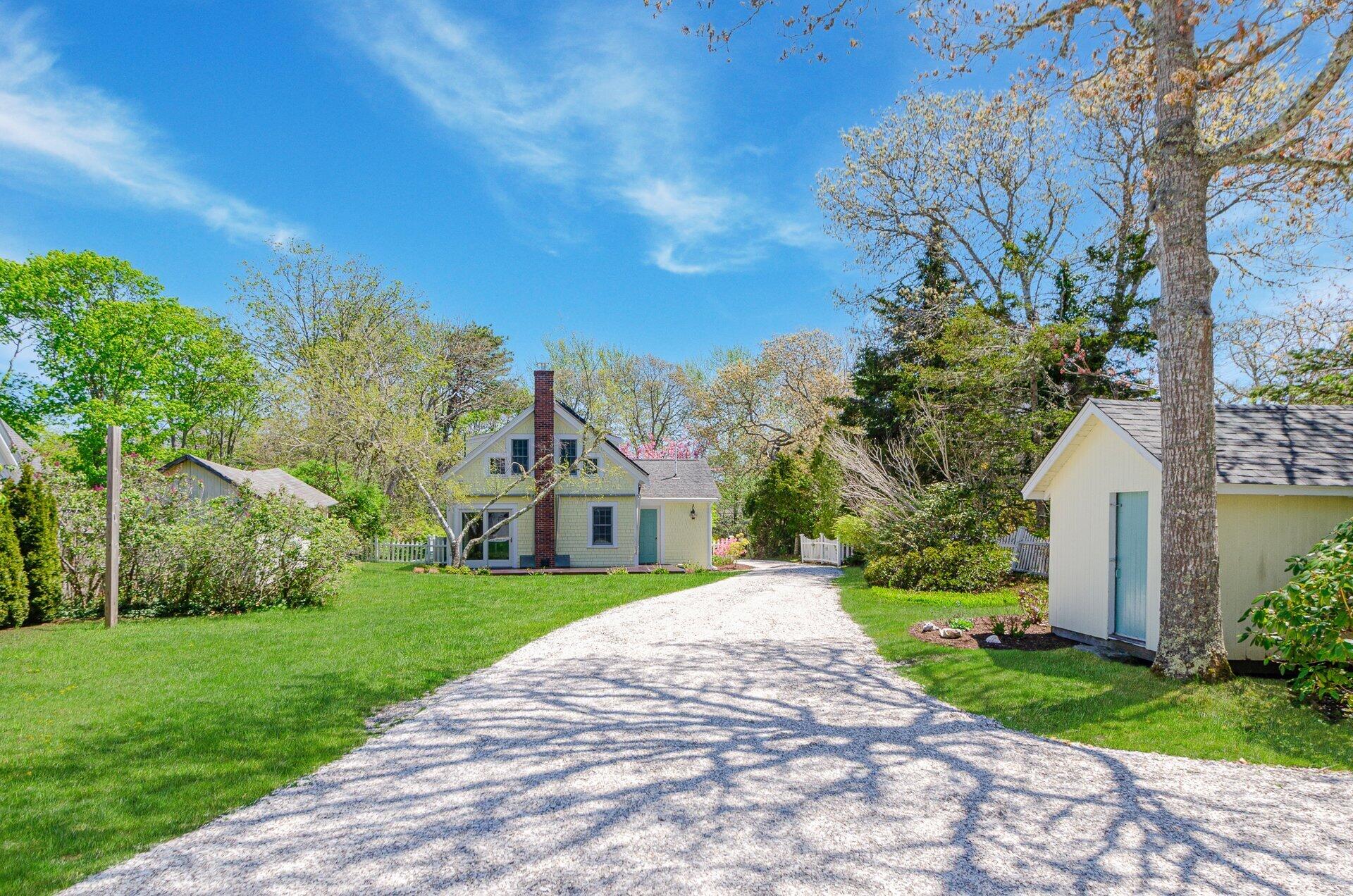 1089 Main Street Cotuit, MA 02635 - Photo 5 of 41 a front view of a house with garden