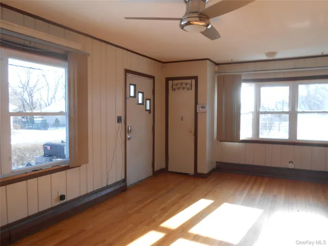 wooden floor in an empty room with a window