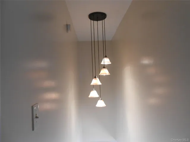 a view of a wooden floor and a chandelier fan