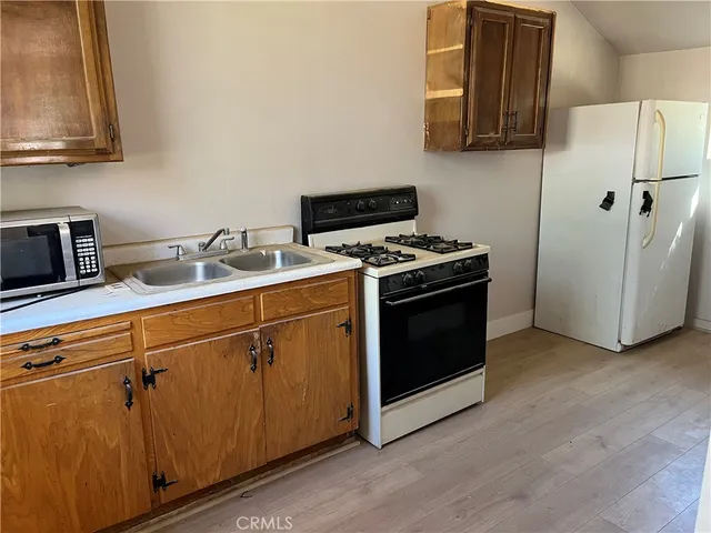 a kitchen with a stove microwave and sink