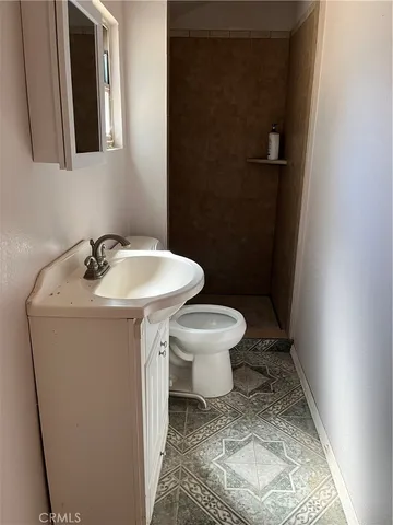 a bathroom with a sink toilet and mirror