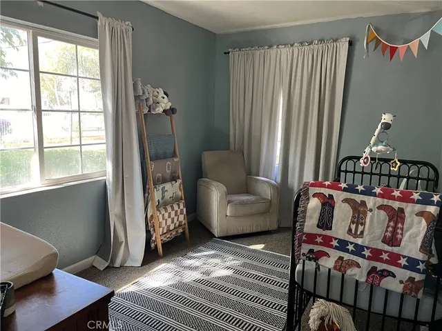 a bedroom with furniture and a window