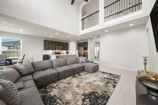 a living room with furniture and kitchen view