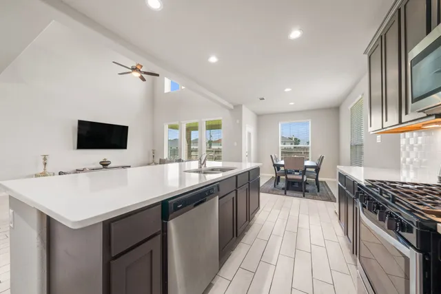 a kitchen with sink stove and cabinets
