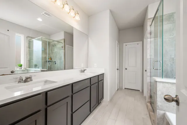 a bathroom with a double vanity sink mirror and double