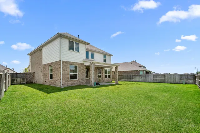 a view of a house with a yard and sitting area