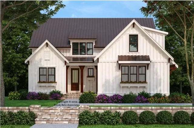 a view of white house with a yard and potted plants