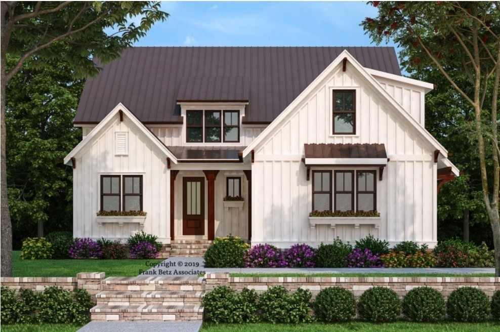 a view of white house with a yard and potted plants