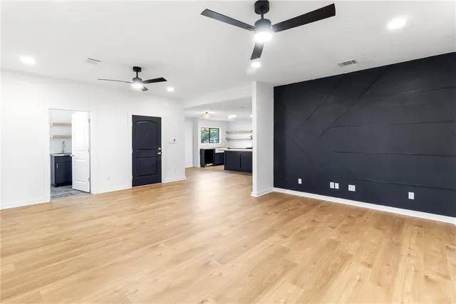 a view of an empty room with a ceiling fan