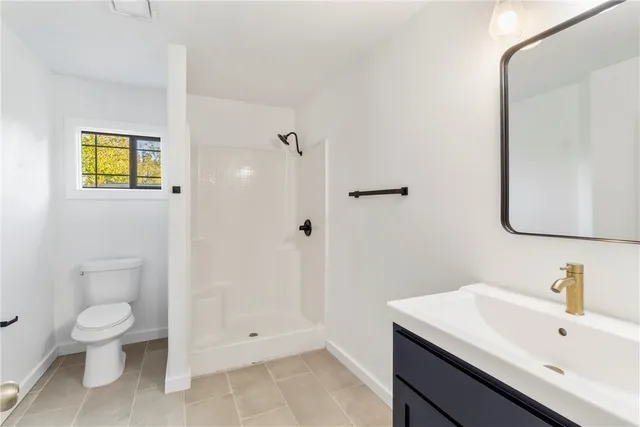 a bathroom with a toilet sink and shower