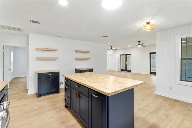 a kitchen with a stove and a kitchen island
