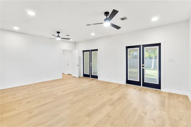 a view of an empty room with a ceiling fan