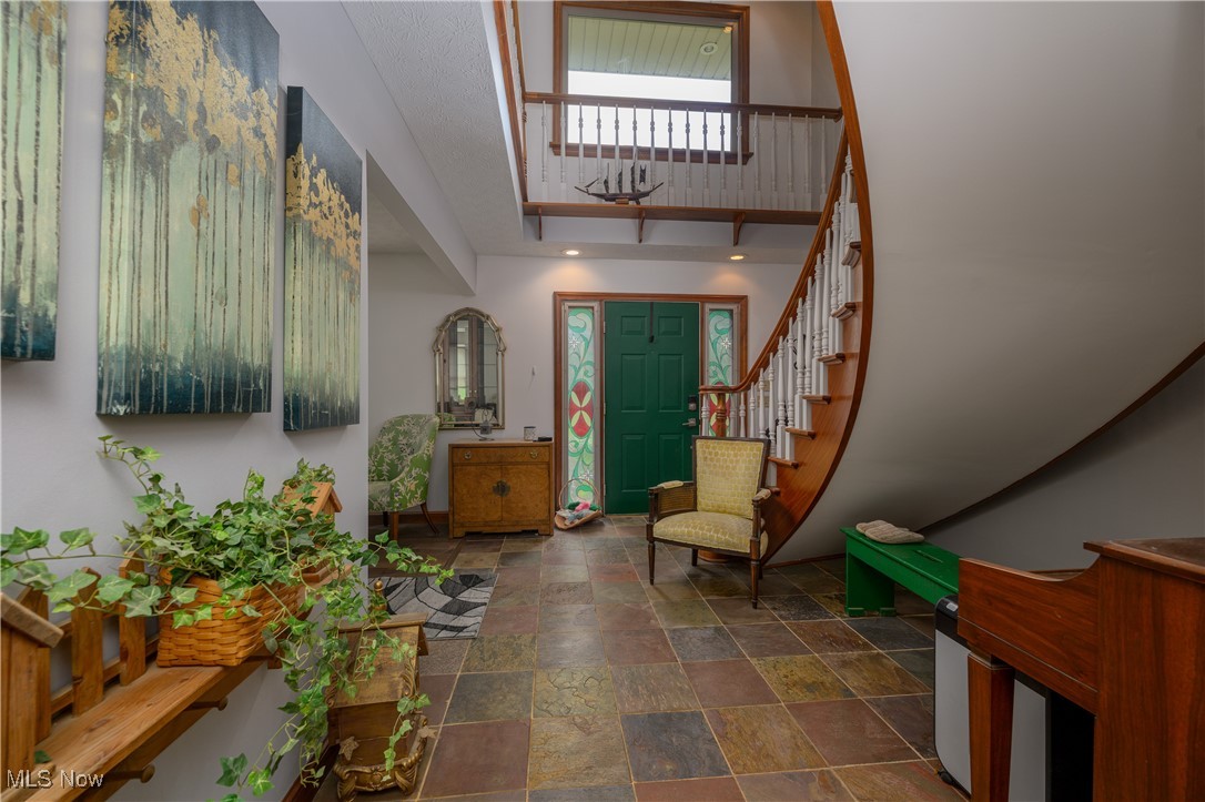1427 Terrace Road Northwest New Philadelphia, OH 44663 - Photo 21 of 44 Entrance foyer featuring stone finish floors, stairway, and a high ceiling