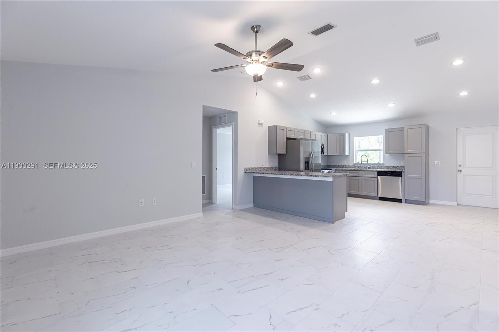 2004 Rosa Court, Unit 2004 Lehigh Acres, FL 33972 - Photo 4 of 23 a view of a kitchen with a sink and a ceiling fan