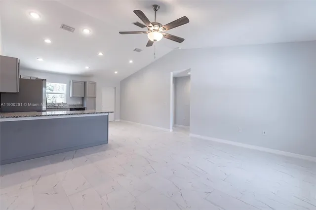 a large kitchen with lot of cabinets and stainless steel appliances