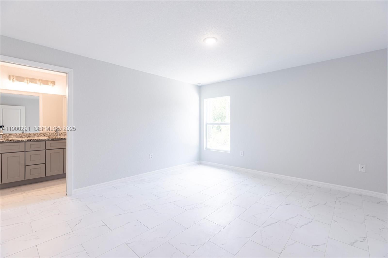 2004 Rosa Court, Unit 2004 Lehigh Acres, FL 33972 - Photo 8 of 23 an empty room with a bathroom and a sink