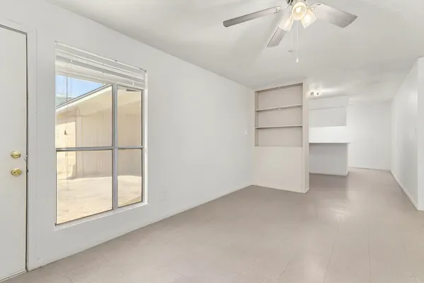 an empty room with windows and closet