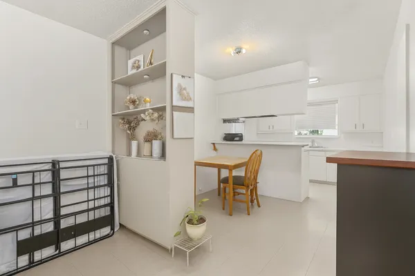 a kitchen with a table chairs and a refrigerator