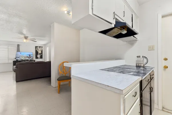 a kitchen with a sink a stove and a refrigerator