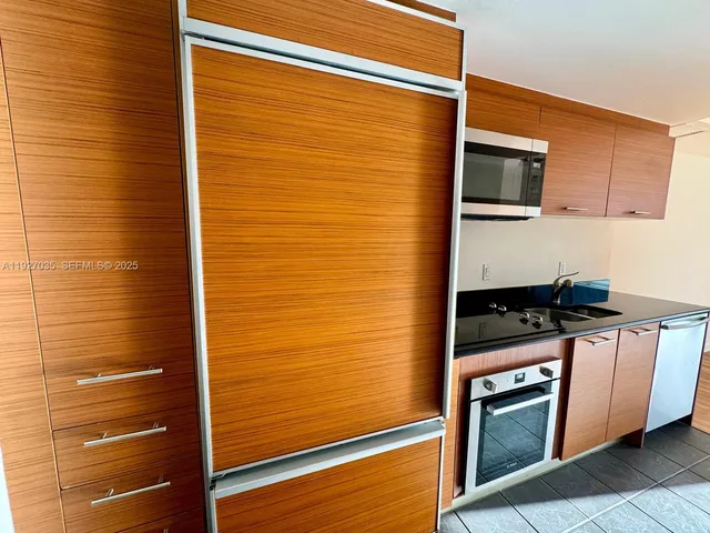 a kitchen with stainless steel appliances a stove and a microwave