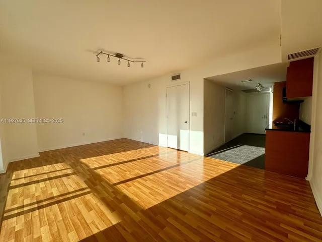 a view of a room with wooden floor