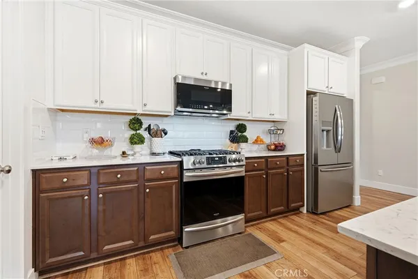 a kitchen with stainless steel appliances granite countertop a refrigerator stove and sink