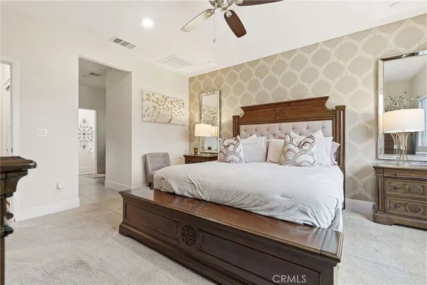 a bedroom with a bed and a chandelier