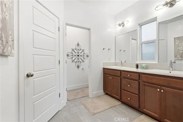 a bathroom with a tub sink vanity and mirror