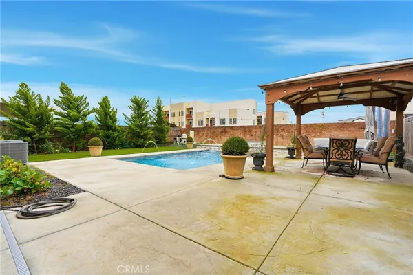 a view of a swimming pool with a patio and garden