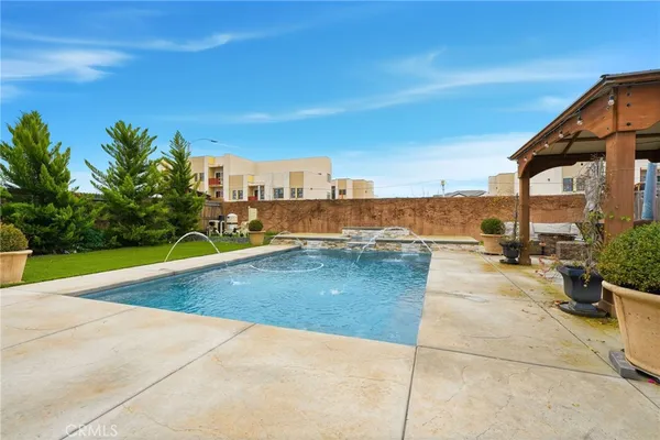 a view of a swimming pool and outdoor seating
