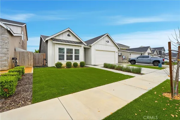 a view of a house with a yard and plants