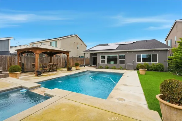 a view of a house with swimming pool and a yard