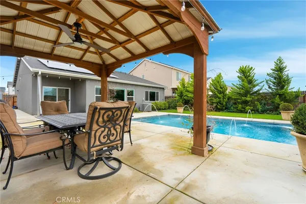a patio with a yard table and chairs