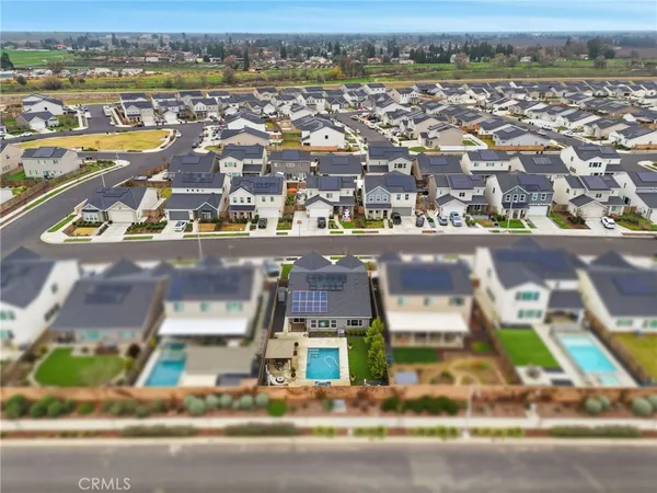 an aerial view of residential houses with city view