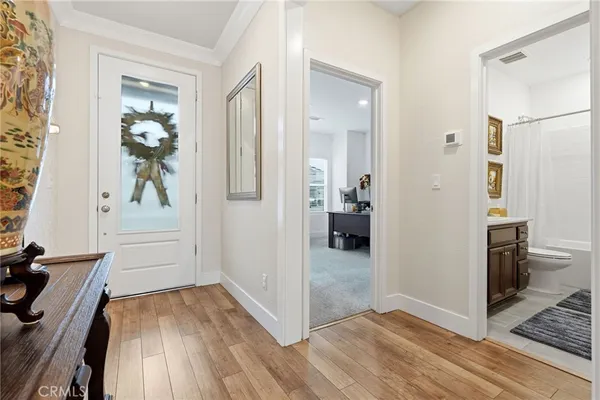 a view of a hallway view with wooden floor and dining room