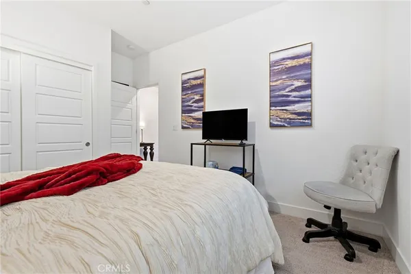 a bedroom with a bed and a chair