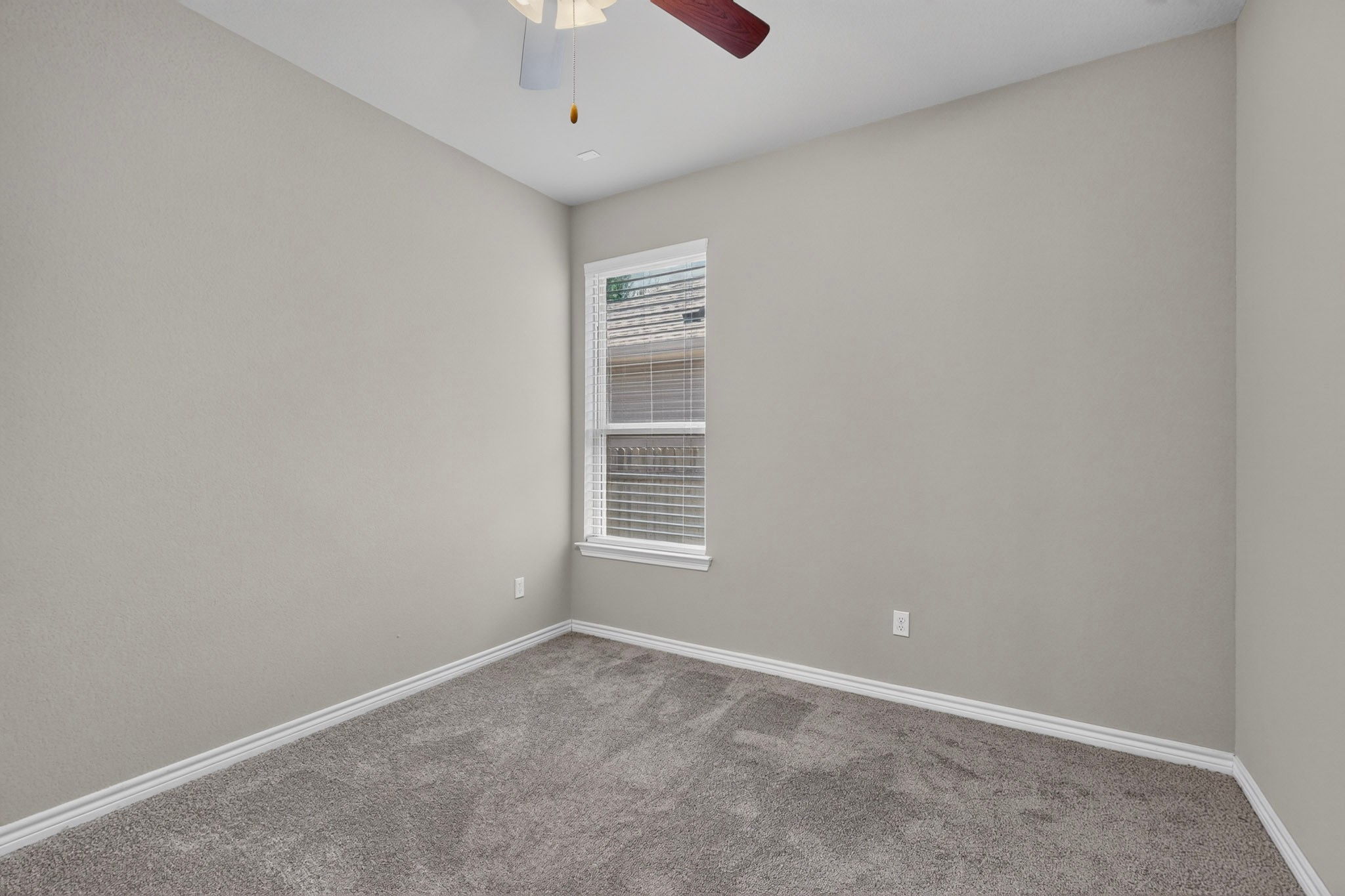 1908 Turtle Bay Loop Leander, TX 78641 - Photo 24 of 38 A well-lit bedroom features plush carpeting and a modern ceiling fan for ultimate comfort.