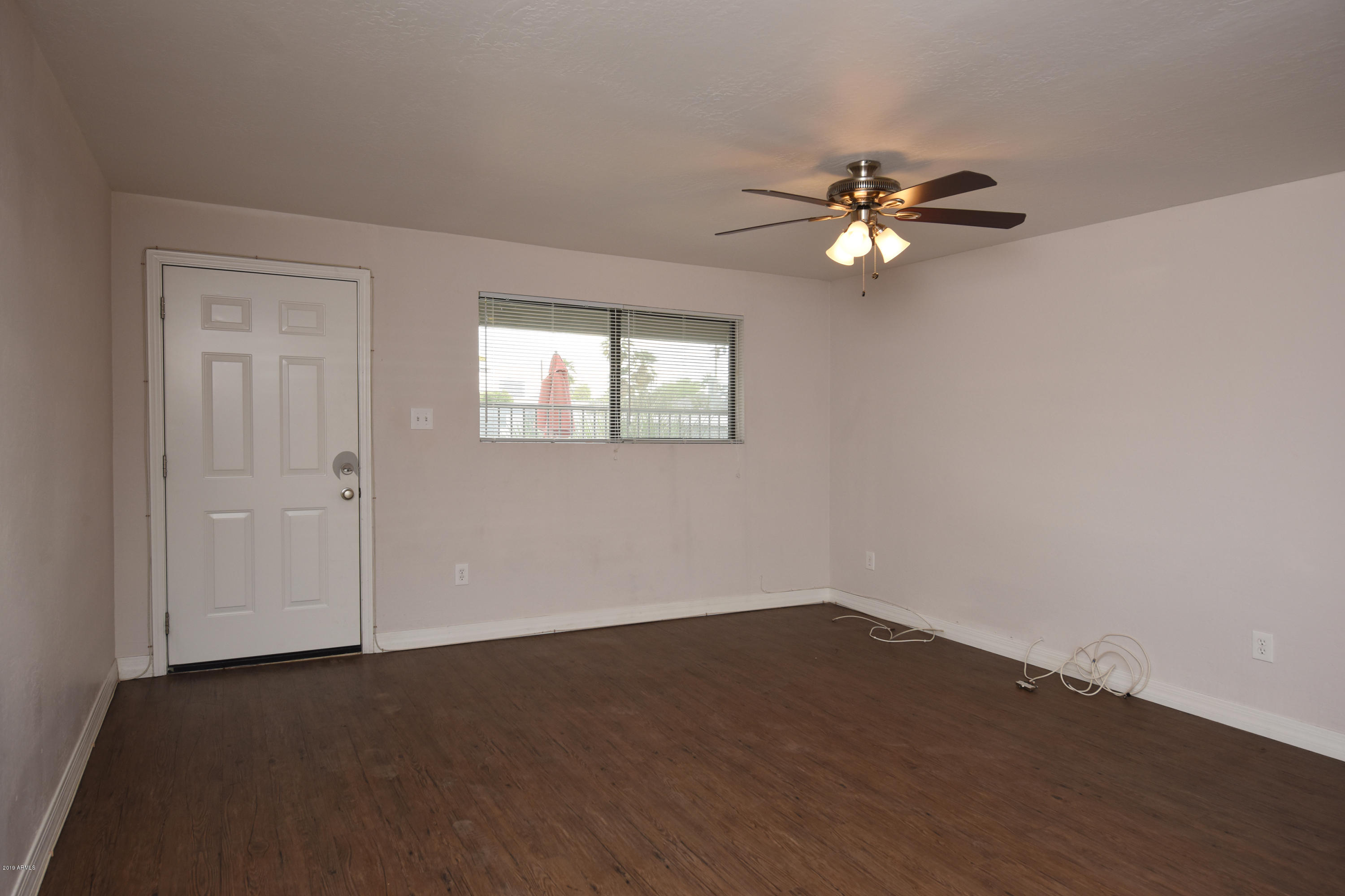 502 East Mariposa Street, Unit 101 Phoenix, AZ 85012 - Photo 11 of 24 a view of a room with wooden floor and fan