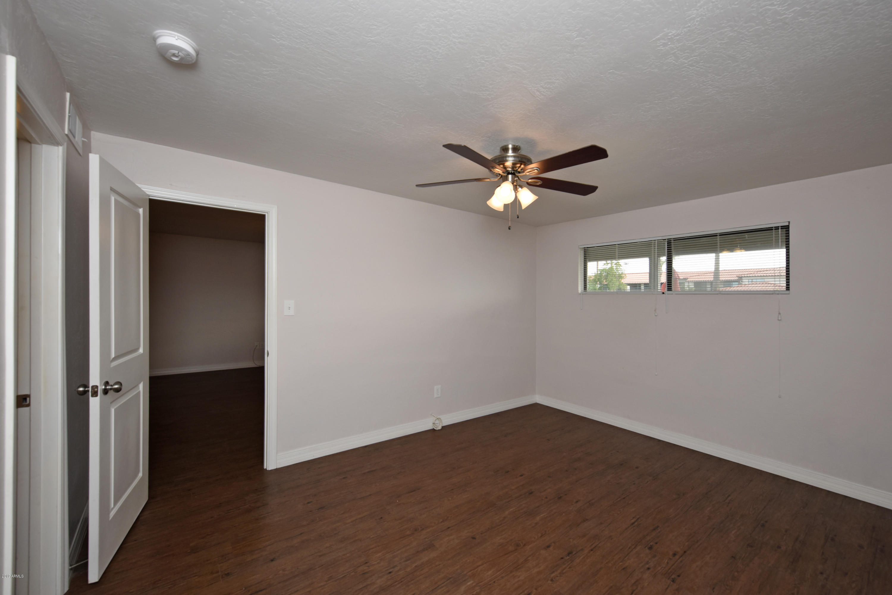 502 East Mariposa Street, Unit 101 Phoenix, AZ 85012 - Photo 14 of 24 wooden floor in an empty room with a window