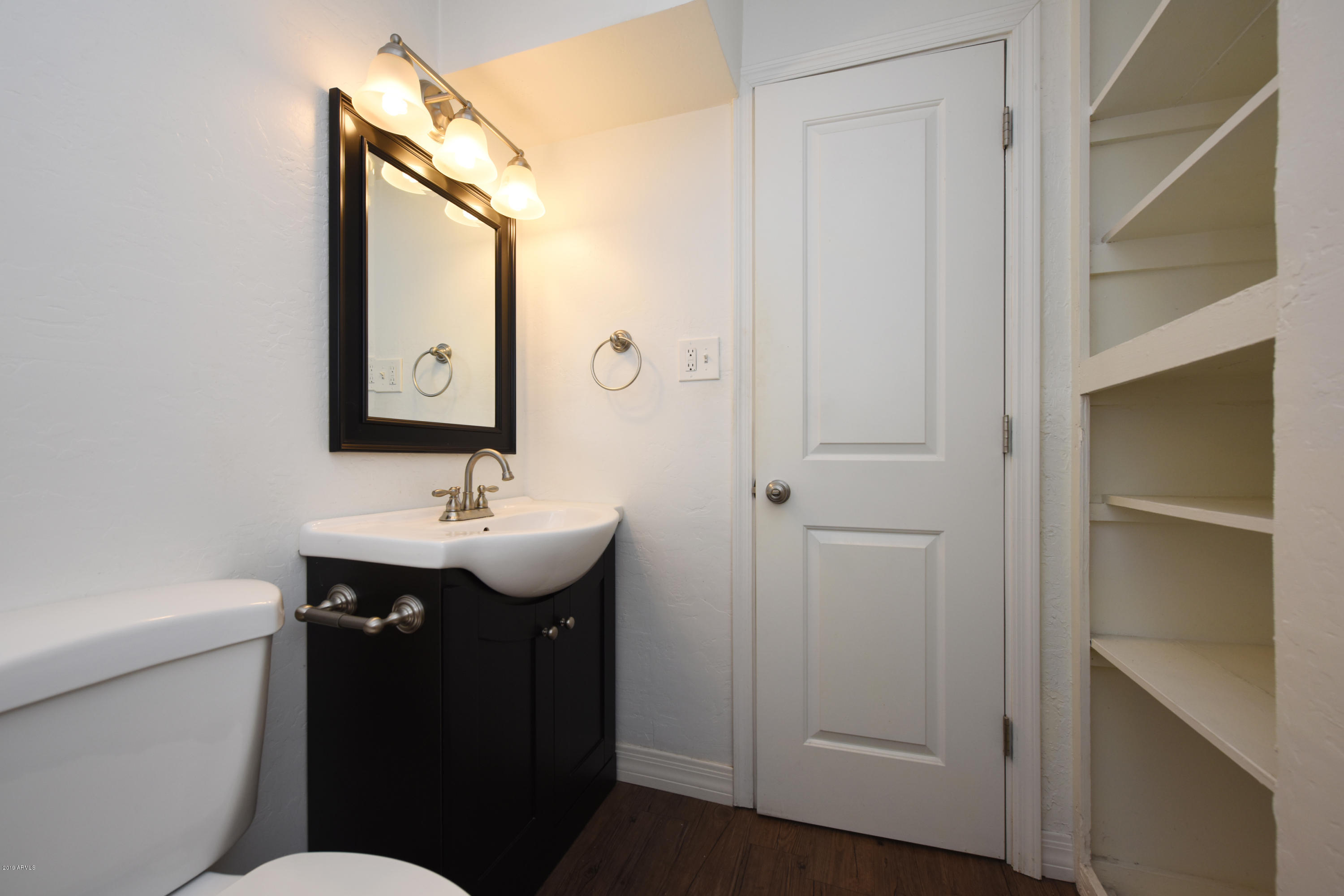 502 East Mariposa Street, Unit 101 Phoenix, AZ 85012 - Photo 18 of 24 a bathroom with a sink and a mirror
