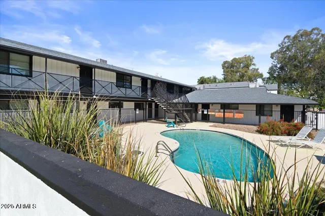 a view of a house with pool and sitting area