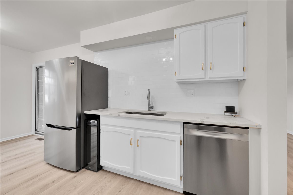 1785 Grosvenor Circle, Unit A Wheaton, IL 60189 - Photo 12 of 37 a kitchen with a refrigerator sink and cabinets