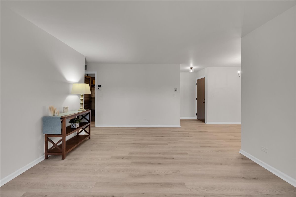 1785 Grosvenor Circle, Unit A Wheaton, IL 60189 - Photo 17 of 37 a view of an empty room with stairs and a window