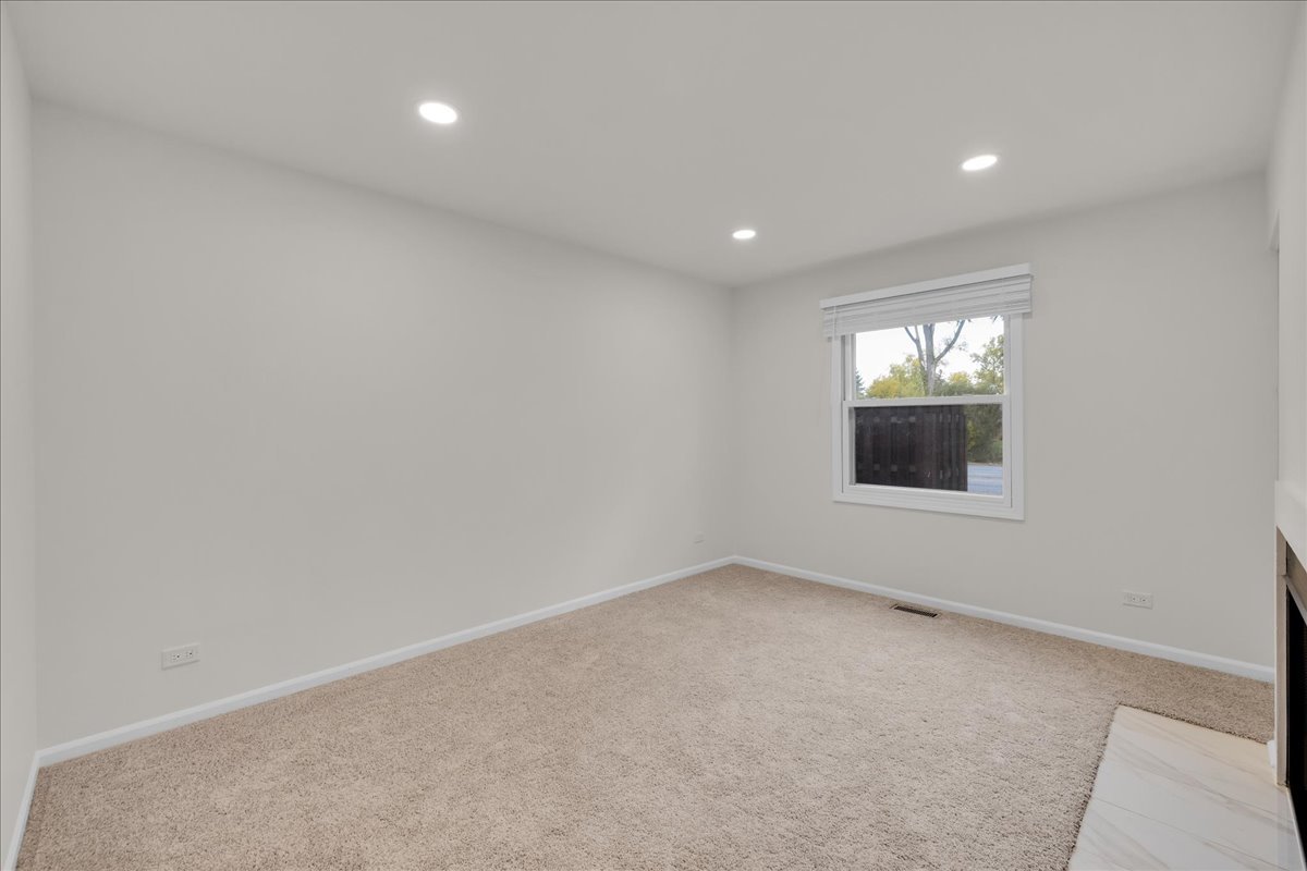 1785 Grosvenor Circle, Unit A Wheaton, IL 60189 - Photo 23 of 37 wooden floor in an empty room with a window