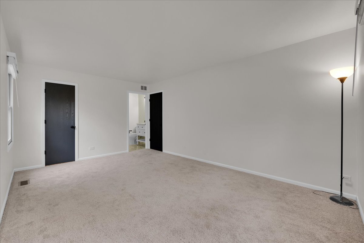 1785 Grosvenor Circle, Unit A Wheaton, IL 60189 - Photo 29 of 37 a view of an empty room with a window