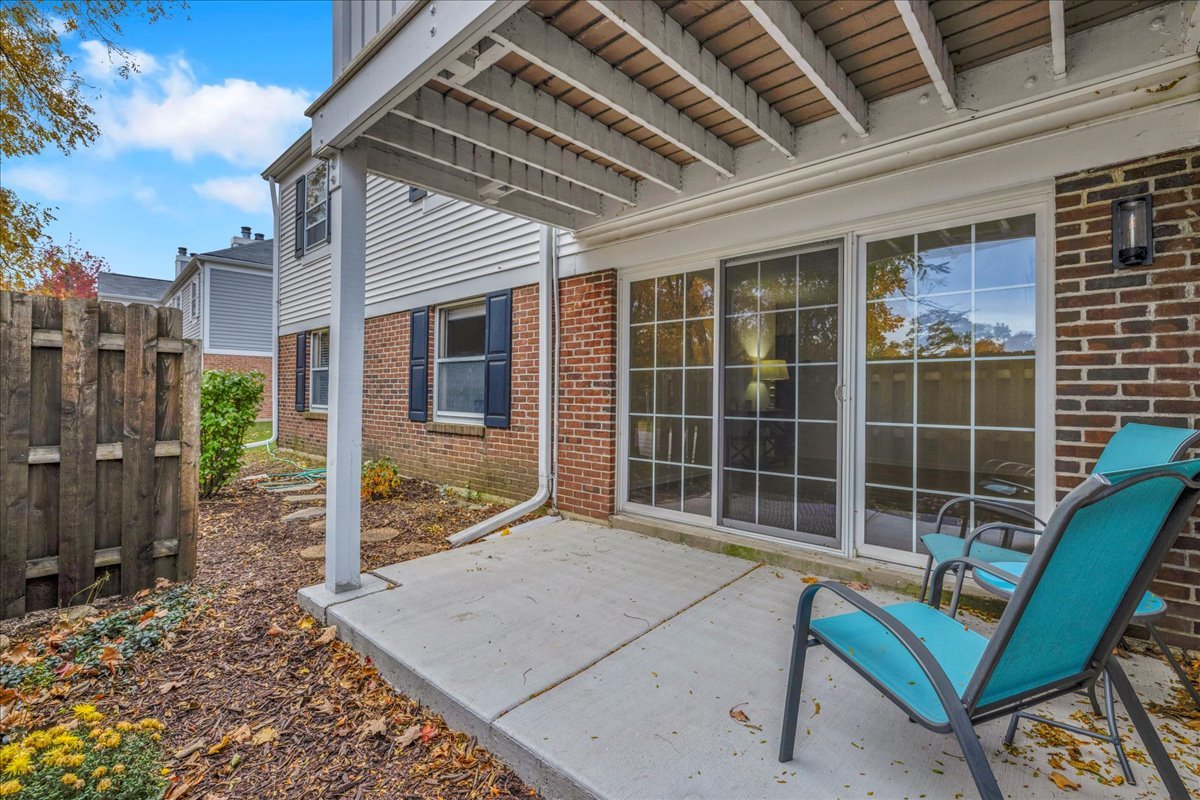 1785 Grosvenor Circle, Unit A Wheaton, IL 60189 - Photo 36 of 37 a view of a lounge chair in the backyard of a house