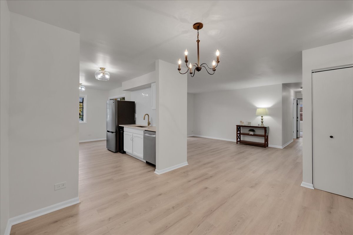 1785 Grosvenor Circle, Unit A Wheaton, IL 60189 - Photo 7 of 37 a view of a kitchen with furniture and an empty room